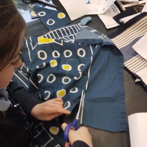 cutting out fabric pieces in our machine sewing class